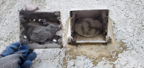 Ouverture extérieure de ventilation en cours de nettoyage